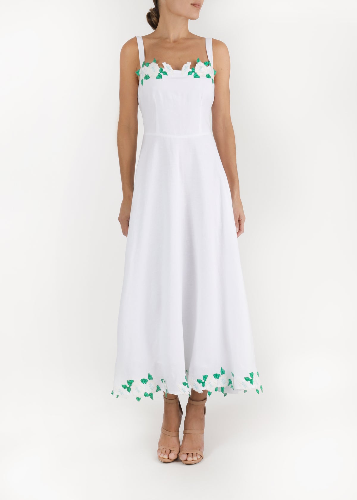 Front of Carlista midi dress with square neckline, wide straps, fitted bodice and green leaf embroidery at hem