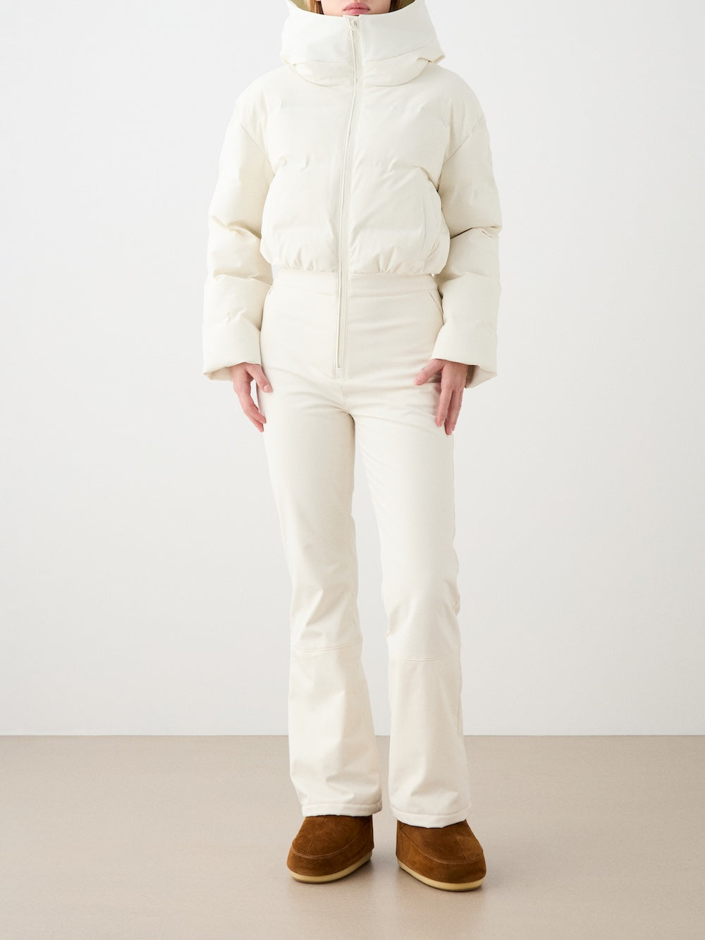 Front view of Aurora Ski Suit in Off White showing its hooded insulated upper and soft-shell lower against a plain studio background