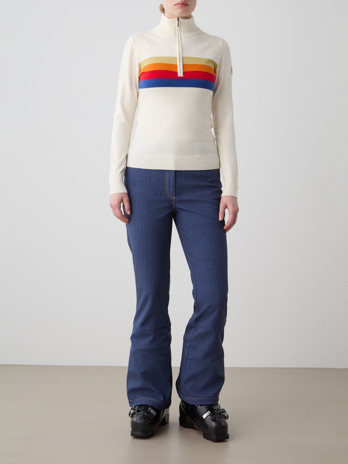 Front view of FreeBird Zip Up in Off White with rainbow stripes and quarter zip collar on a model against a light background