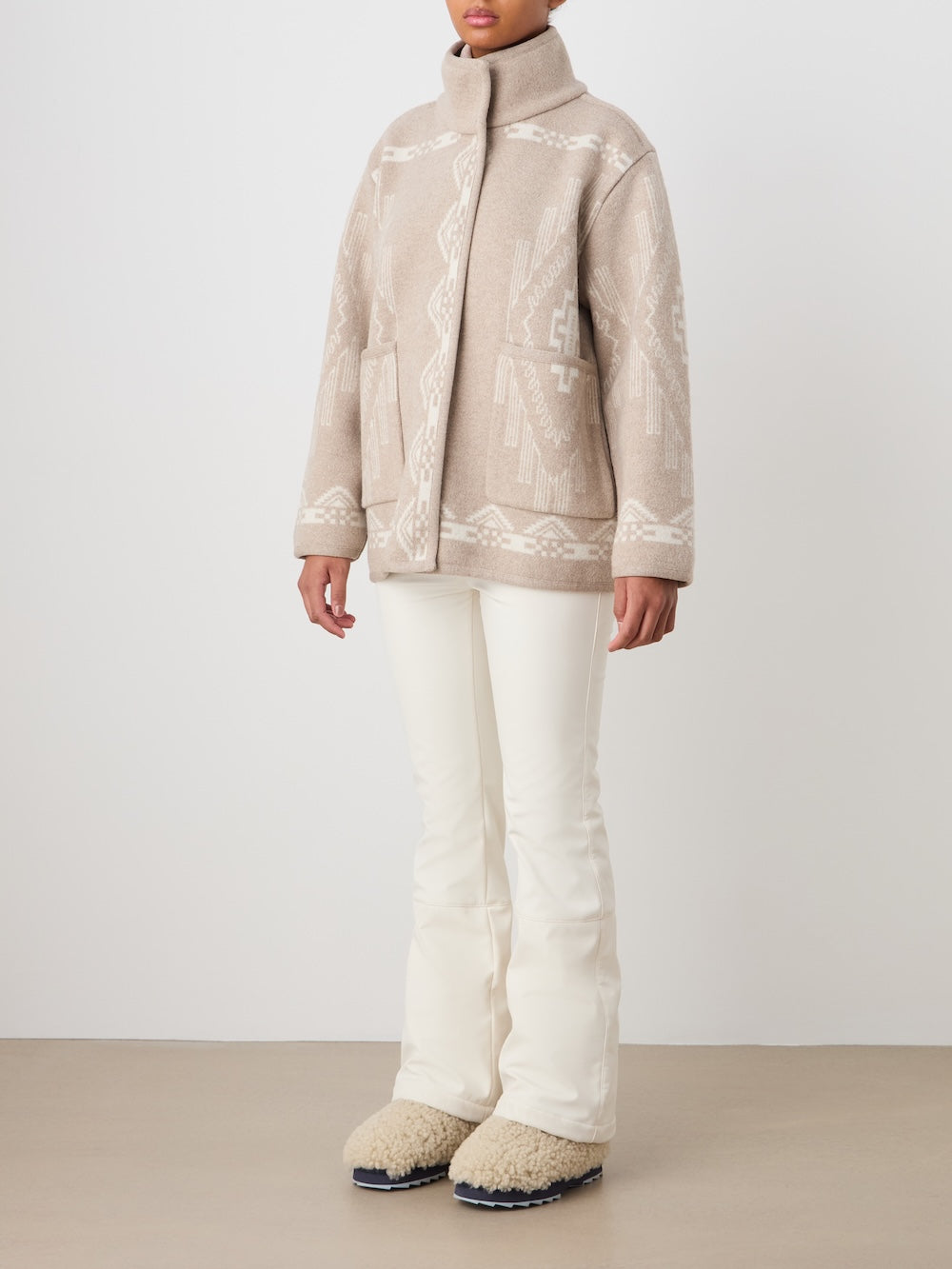 Front view of Pioneer Jacket in Beige showcasing jacquard pattern and oversized fit on a model in a neutral studio