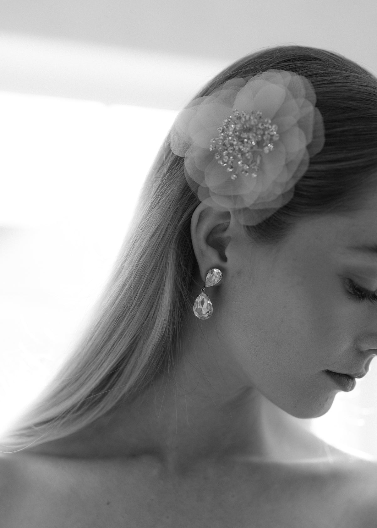 Side view of Chantrell Barrette in Cream showcasing silk petals and crystal stamen in a model’s hair
