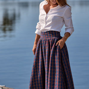 Women’s Audrey Skirt in navy, red, and green Tinsel Tartan with subtle metallic thread, featuring a full gathered midi-length silhouette.