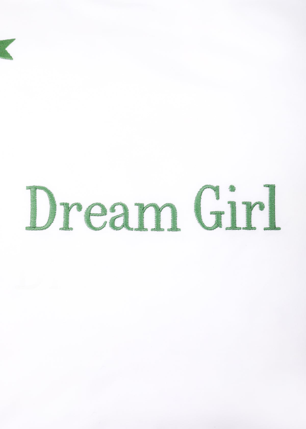 Close-up front of Dream Girl Stars mini pillow showing green Dream Girl embroidery and a small green star on white background
