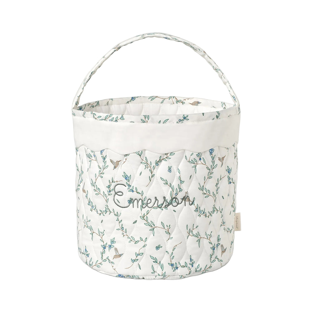 Quilted basket with Secret Garden pattern on a white background.
