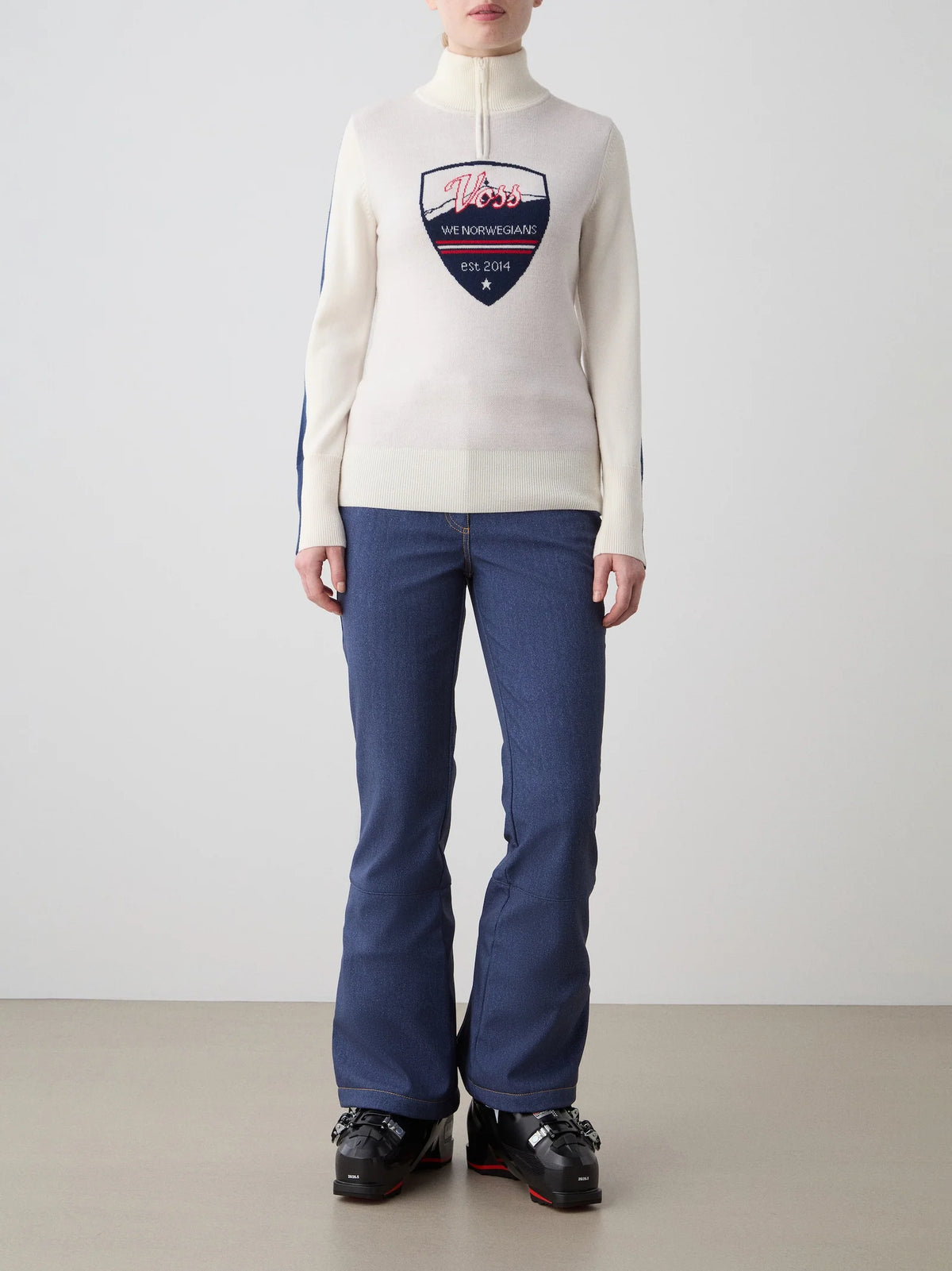 Front view of AfterSki Zip Up in Cream showcasing its slim fit, quarter zip, and jacquard chest artwork on a light gray studio background