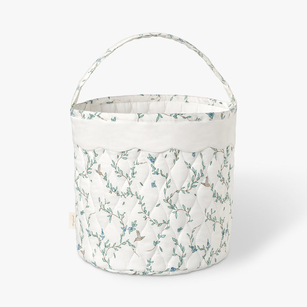 Quilted basket with Secret Garden pattern on a white background.