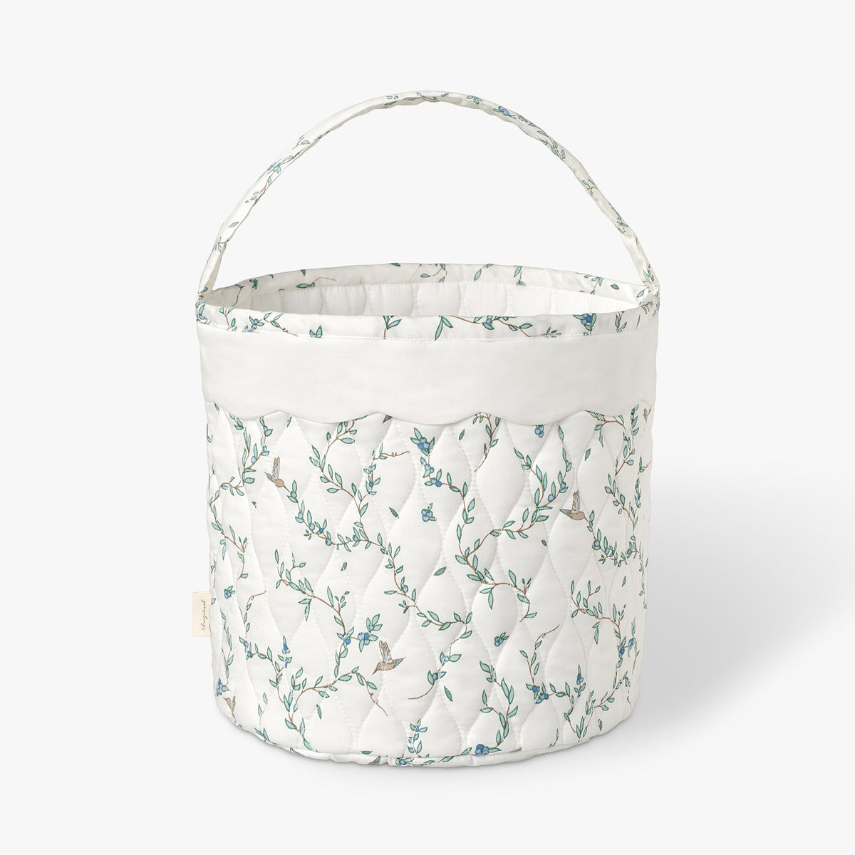 Quilted basket with Secret Garden pattern on a white background.
