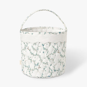 Quilted basket with Secret Garden pattern on a white background.