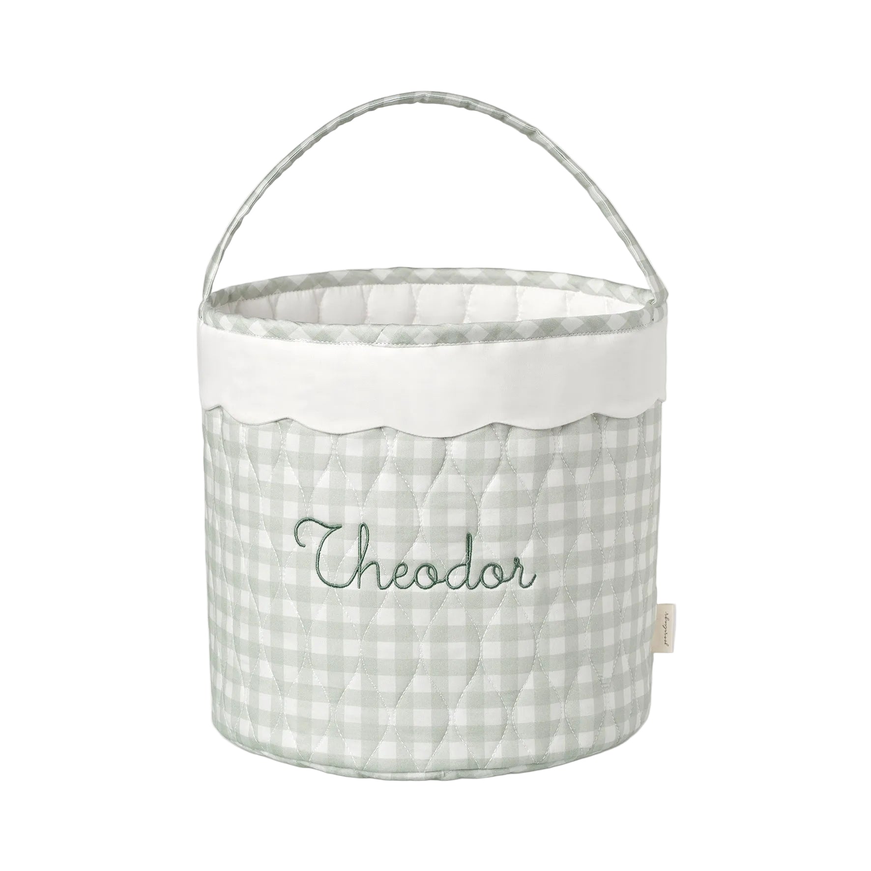Fabric basket with a green gingham pattern and embroidered name on a white background
