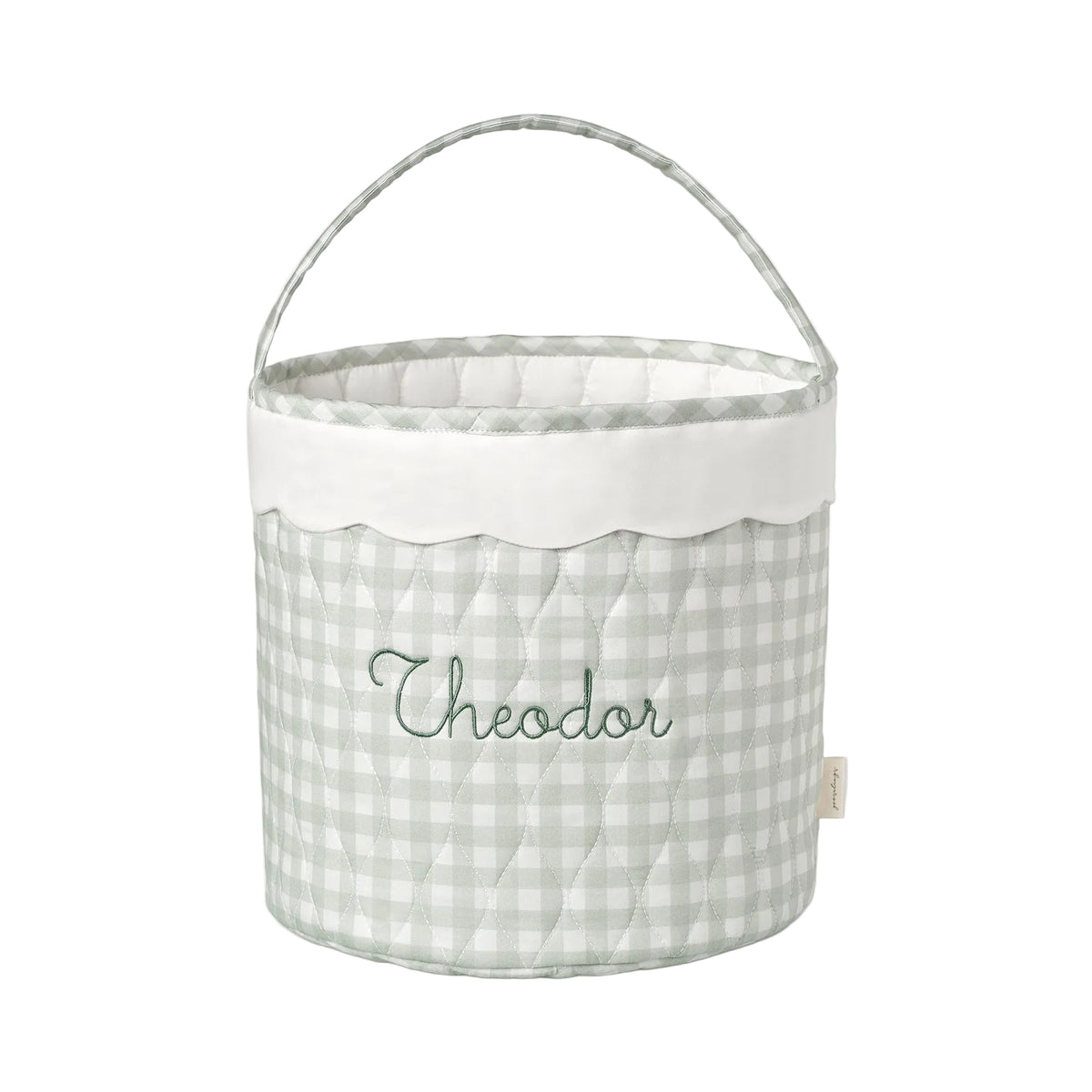 Fabric basket with a green gingham pattern and embroidered name on a white background