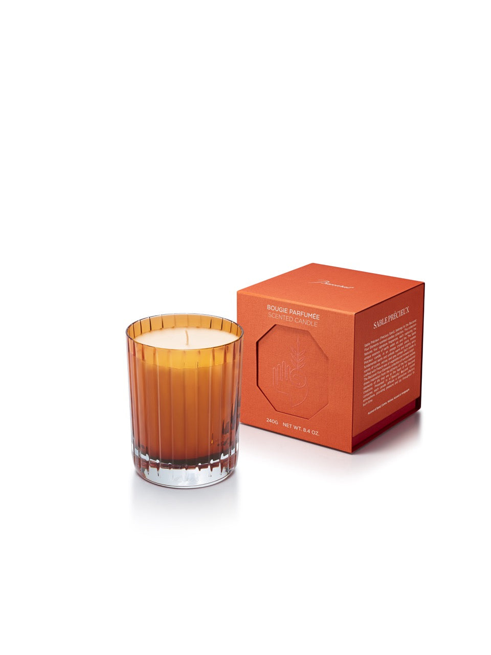 Front view of Harmonie Four Elements Candle in Earth showcasing an orange crystal container with matching box on white background