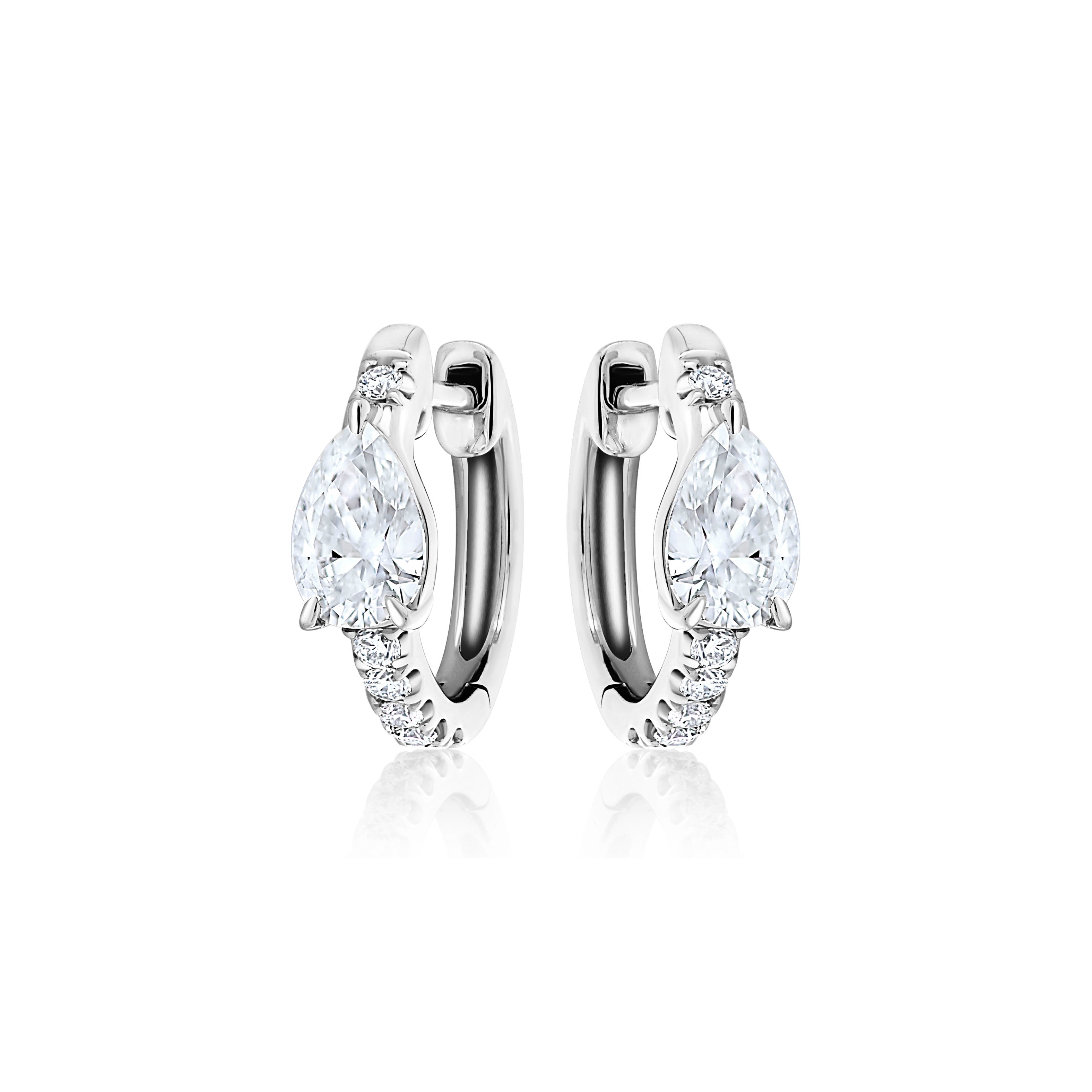 The Pavé Huggie with Pear Diamonds earrings showcase a large teardrop-shaped clear gemstone and smaller round stones on the front, beautifully displayed on a white background.
