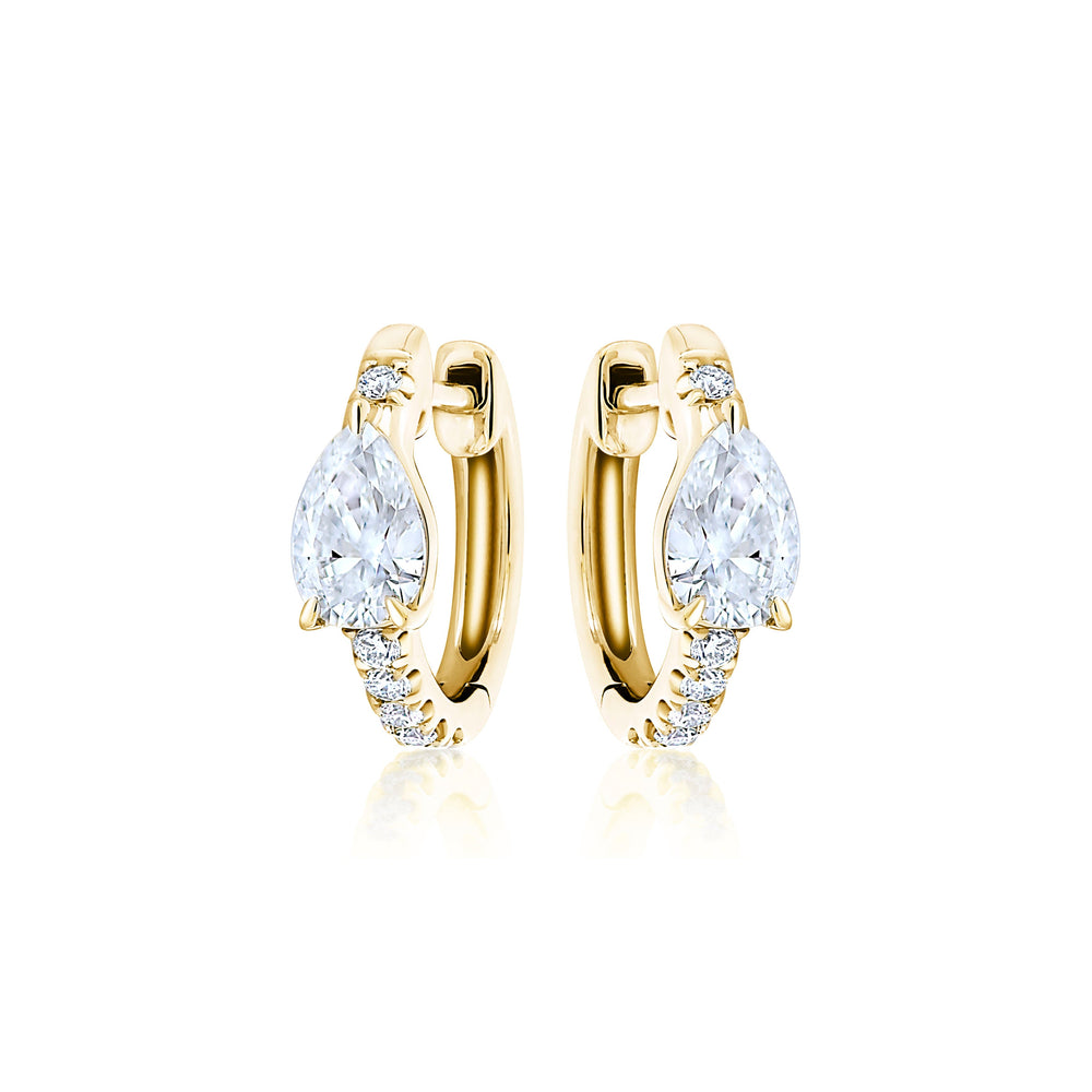 Pavé Huggie with Pear Diamonds: 18k gold hoop earrings with a pear-shaped diamond center and small round stones along the front, shown on a white background.