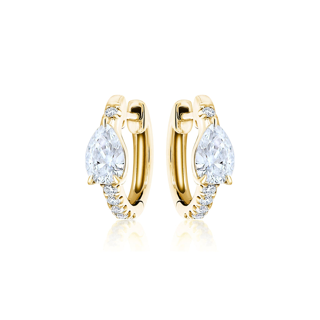 Pavé Huggie with Pear Diamonds: 18k gold hoop earrings with a pear-shaped diamond center and small round stones along the front, shown on a white background.