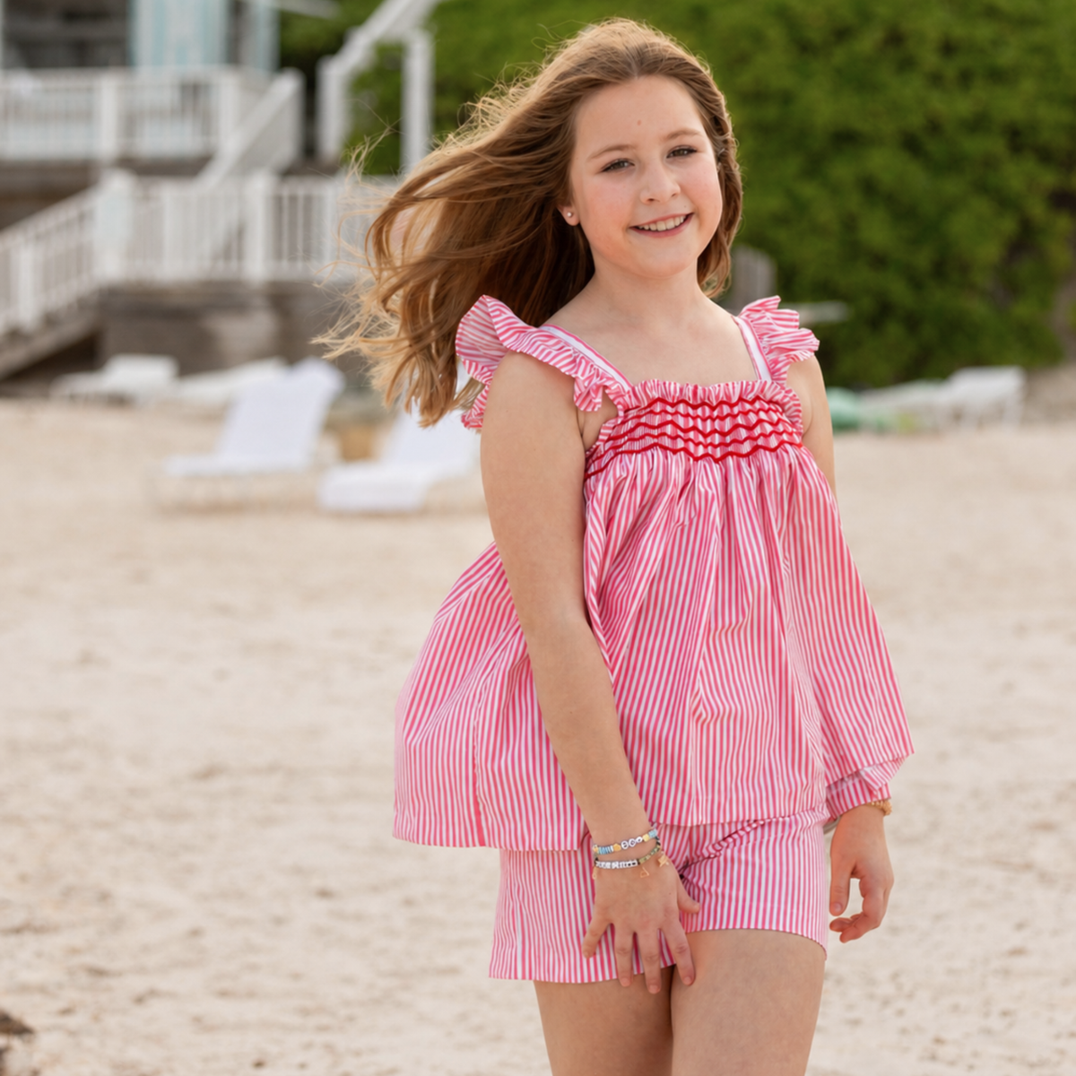 Henry Duvall girls smocked shorts set in red & white strip, a classic two-piece outfit with flutter sleeves and blue embroidered smocking.