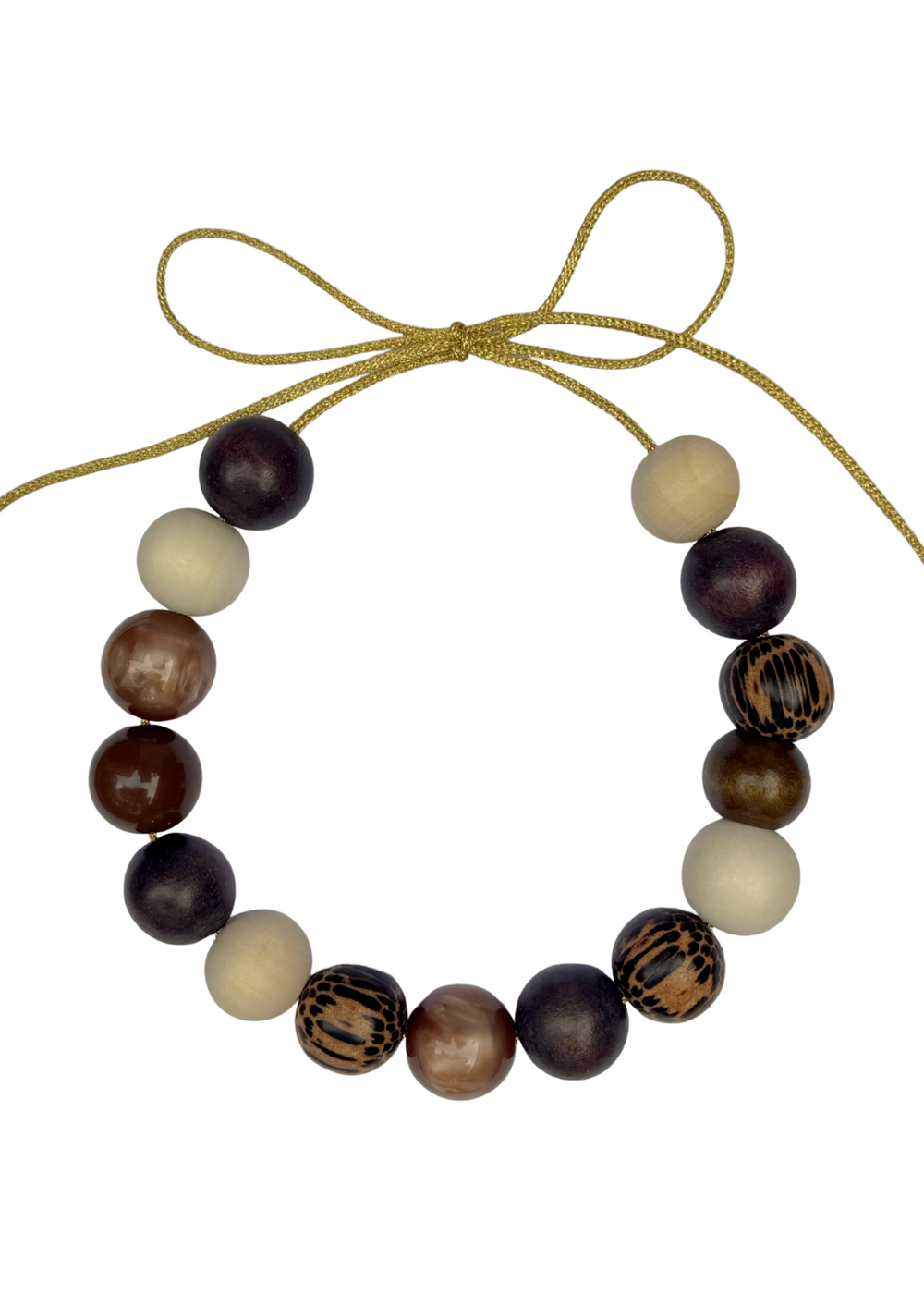 Top-down view of Verbier Bubble Necklace showing mixed wood and glossy beads on a gold lurex cord with adjustable bow on white background