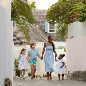 Woman wearing the Henry Duvall Kate Dress, a breezy striped women’s dress with coastal style.