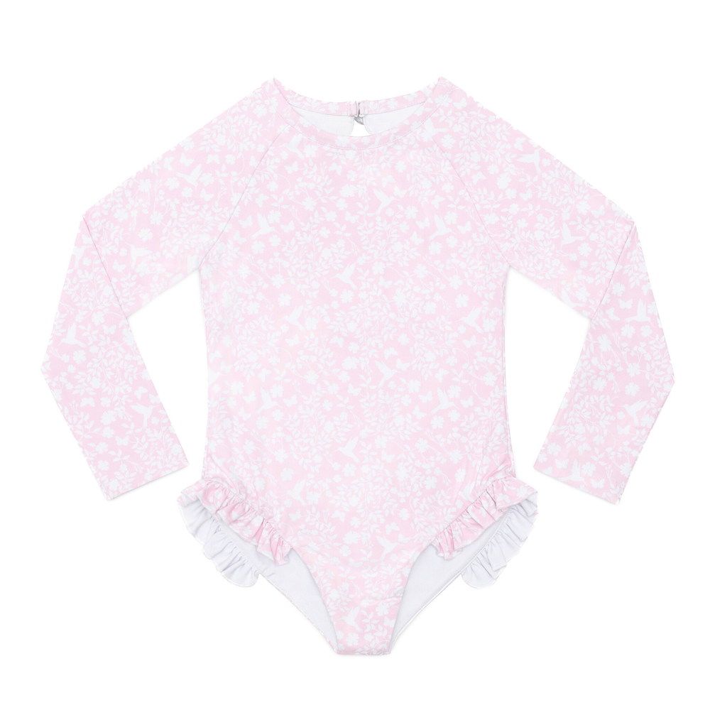 Front flat-lay of girls’ long-sleeve rashguard swimsuit in Coral Sand Chinz, high neckline, ruffled leg trim on white