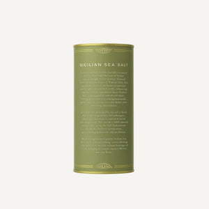 Green cylindrical container of Sicilian sea salt on a white background