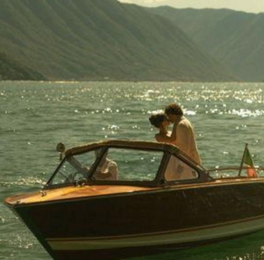 A vintage boat and a few vintage bottles, drifting across Lake Garda.