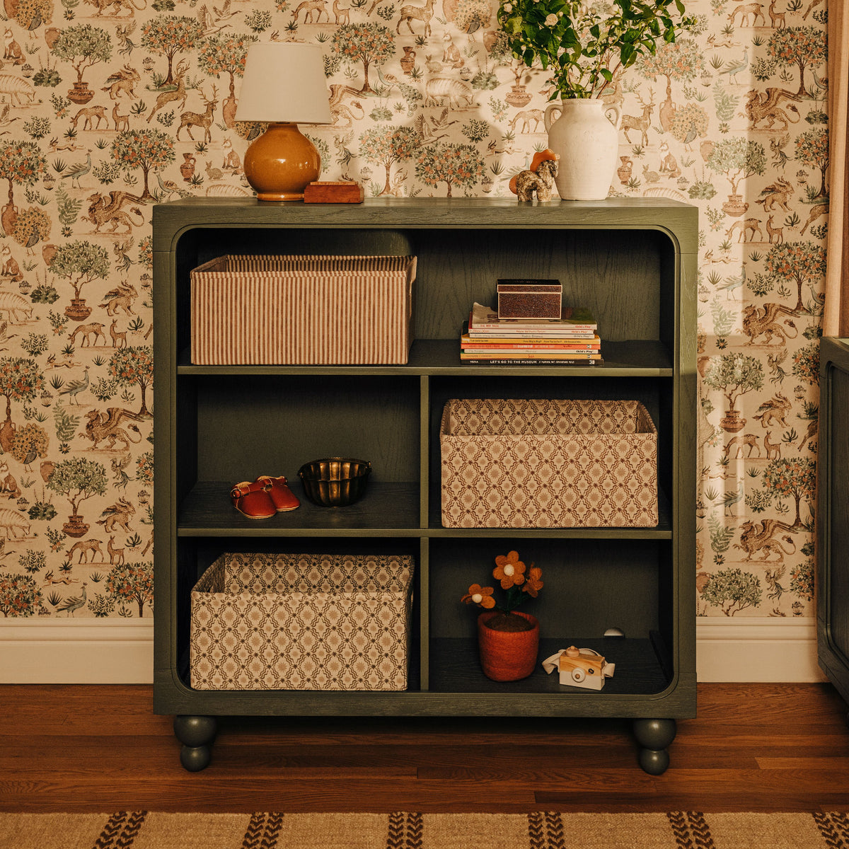Front view of Astre Assembled Bookcase by Nate Berkus in Archival Elm with open shelves and rounded feet