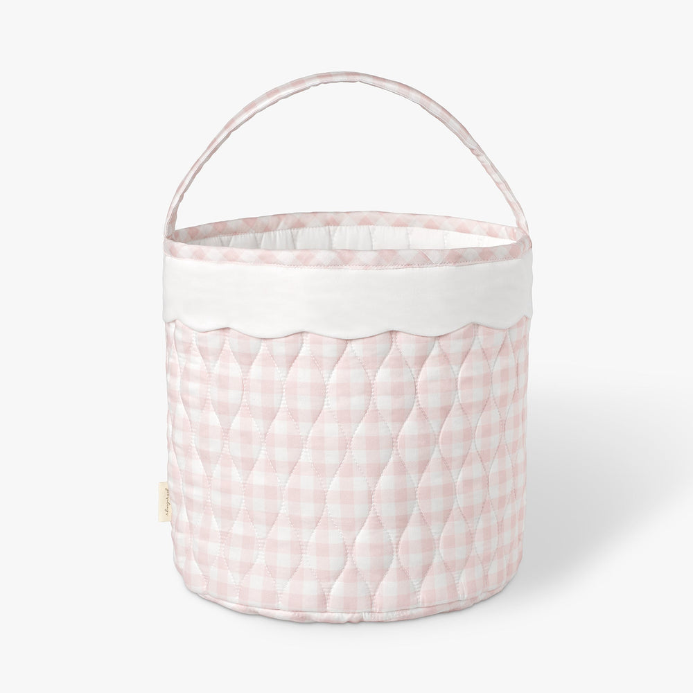 Quilted storage basket with pink and white checkered pattern on a white background