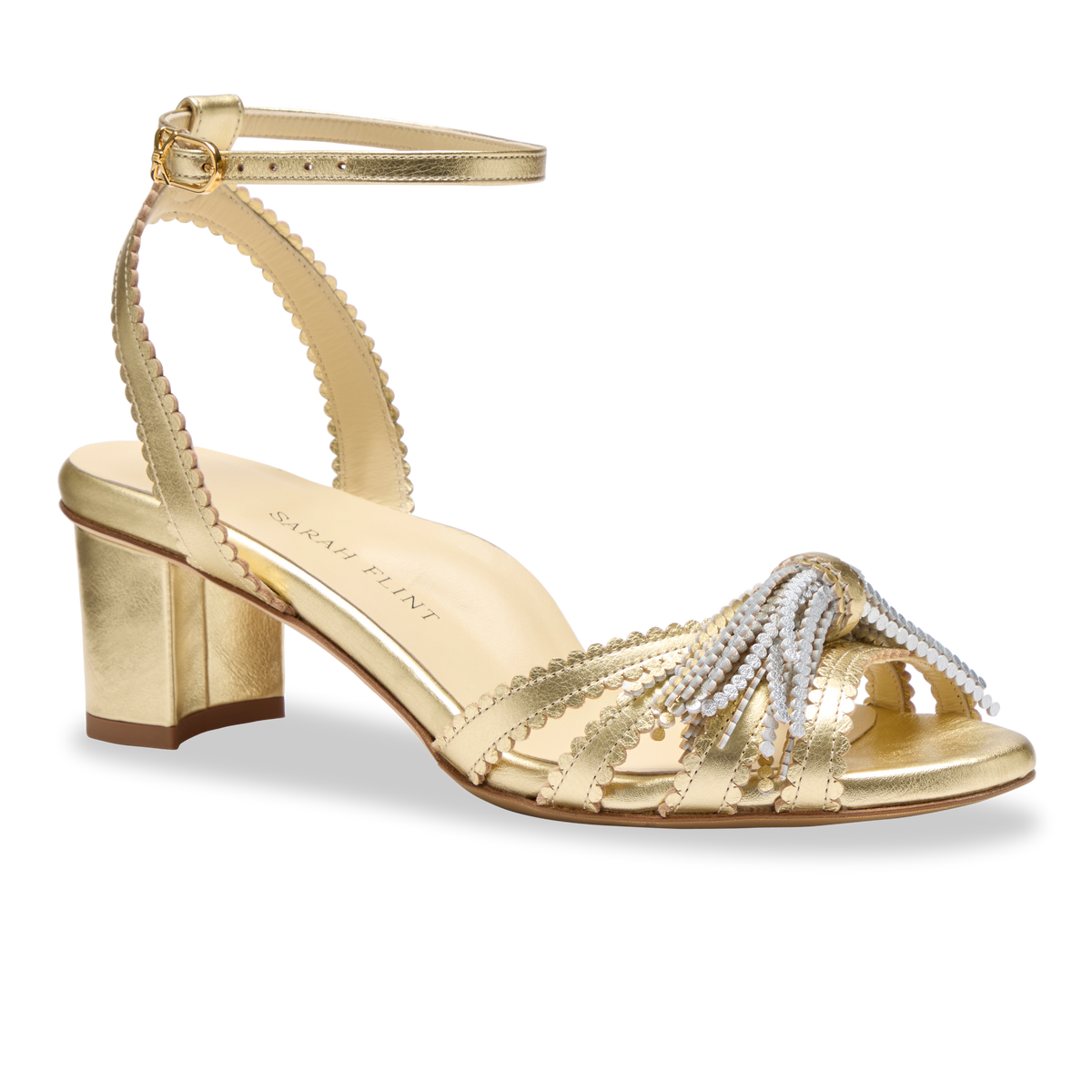 Side view of Perfect Kathryn 50 in Warm Gold Calf sandal showcasing its two-tone metallic tassel against a plain background