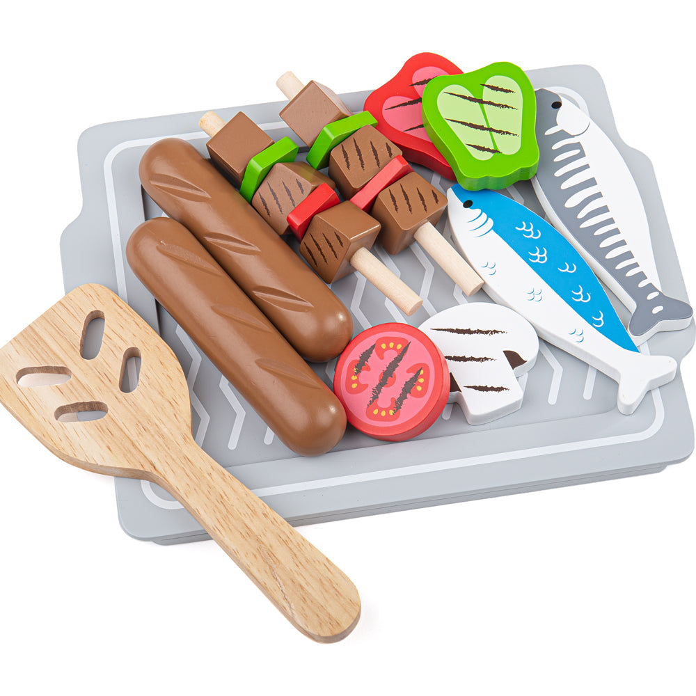 Top view of Table Top BBQ toy showcasing wooden play food, skewers, fish, sausages, and spatula on a gray grill tray