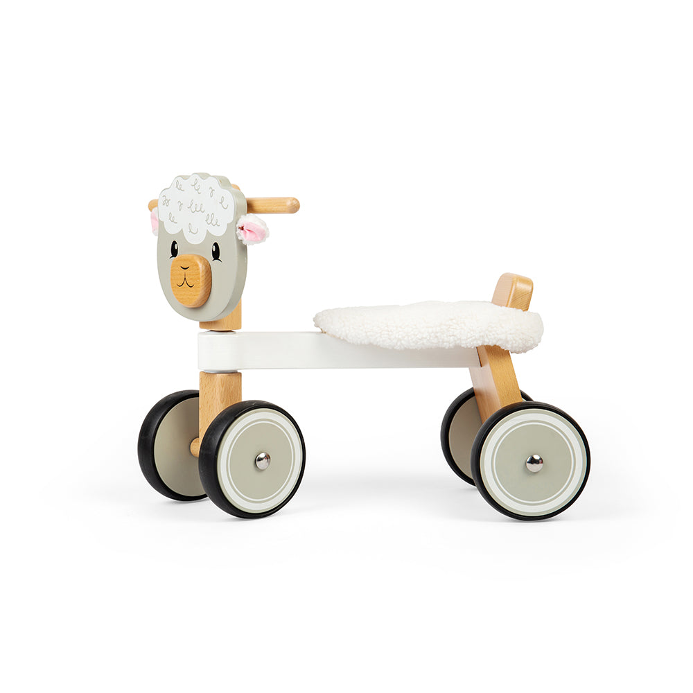 Side view of Ride On Sheep showcasing fluffy seat, wooden handlebars, and four wheels against a white background