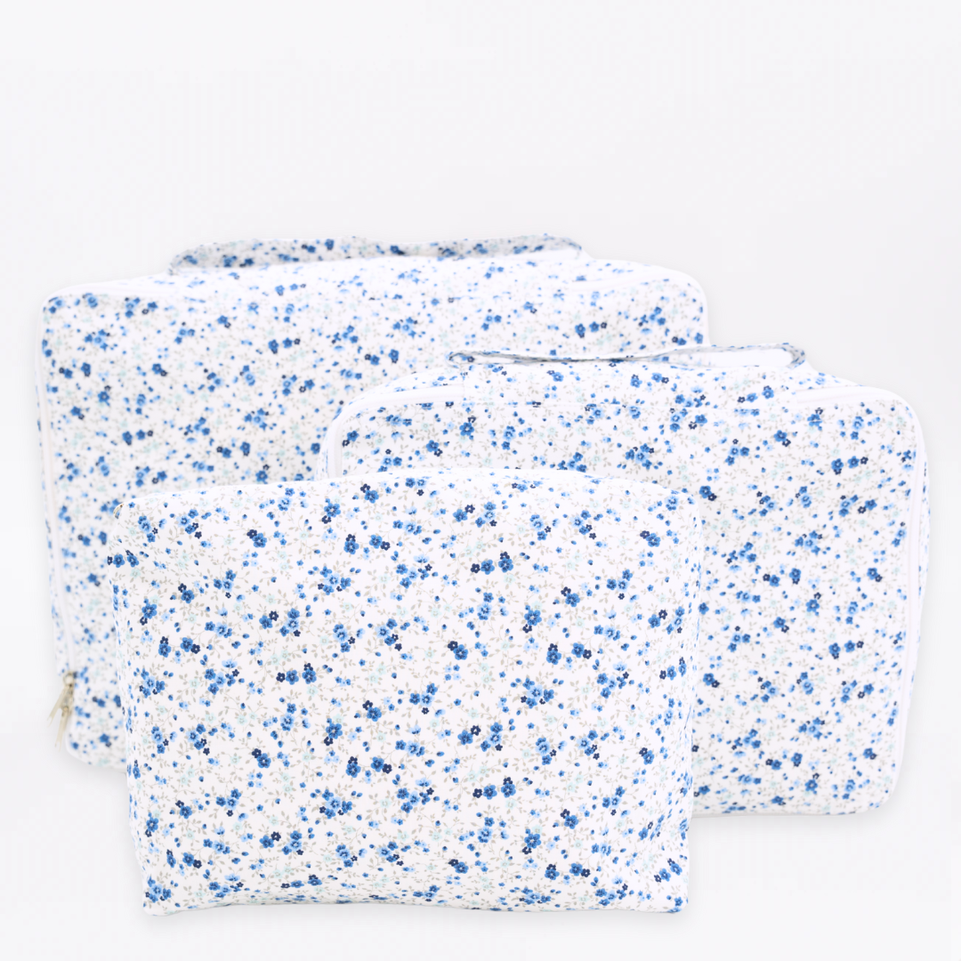 Front view of Emmie Packing Cubes showcasing assorted sizes and signature floral print on a white background