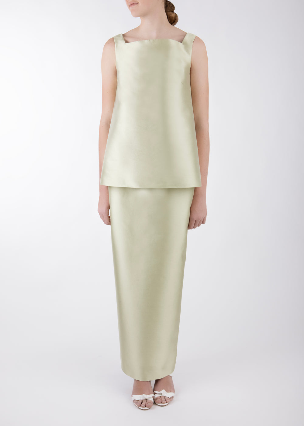 Front view of Louisa skirt in sage on model showcasing high-waist column silhouette and smooth silk-wool finish on white background