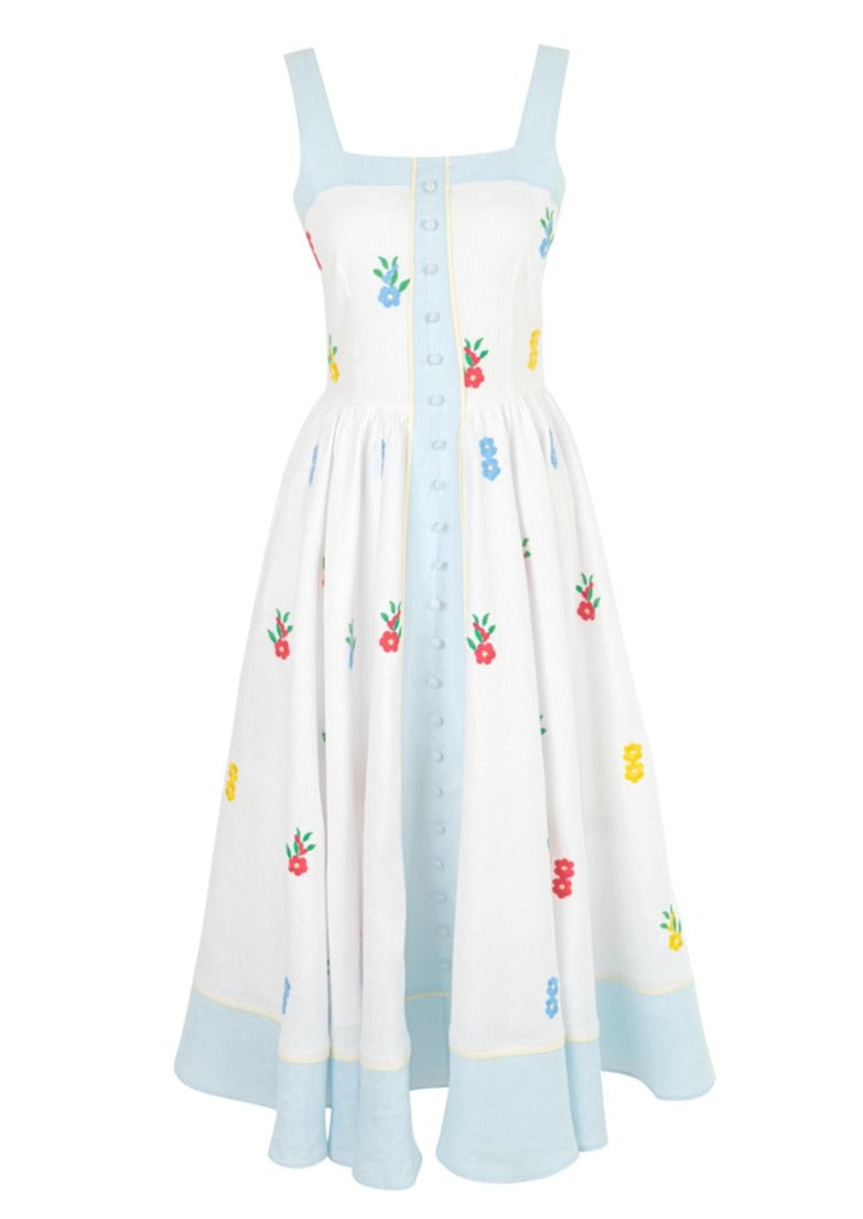 Front view of OTM Exclusive: Brooke Dress showcasing colorful floral embroidery, pale blue trim, and button front against a white background