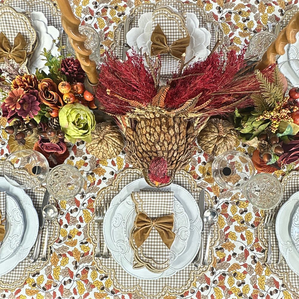 Decorative Thanksgiving table setting with tan gingham placemats and napkins.