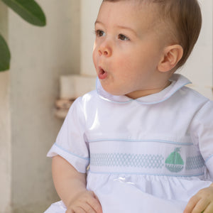 Henry Duvall Charlie Bubble for boys in white cotton with Bailey’s Bay Blue trim and smocked sailboat, classic summer baby boy outfit with Peter Pan collar