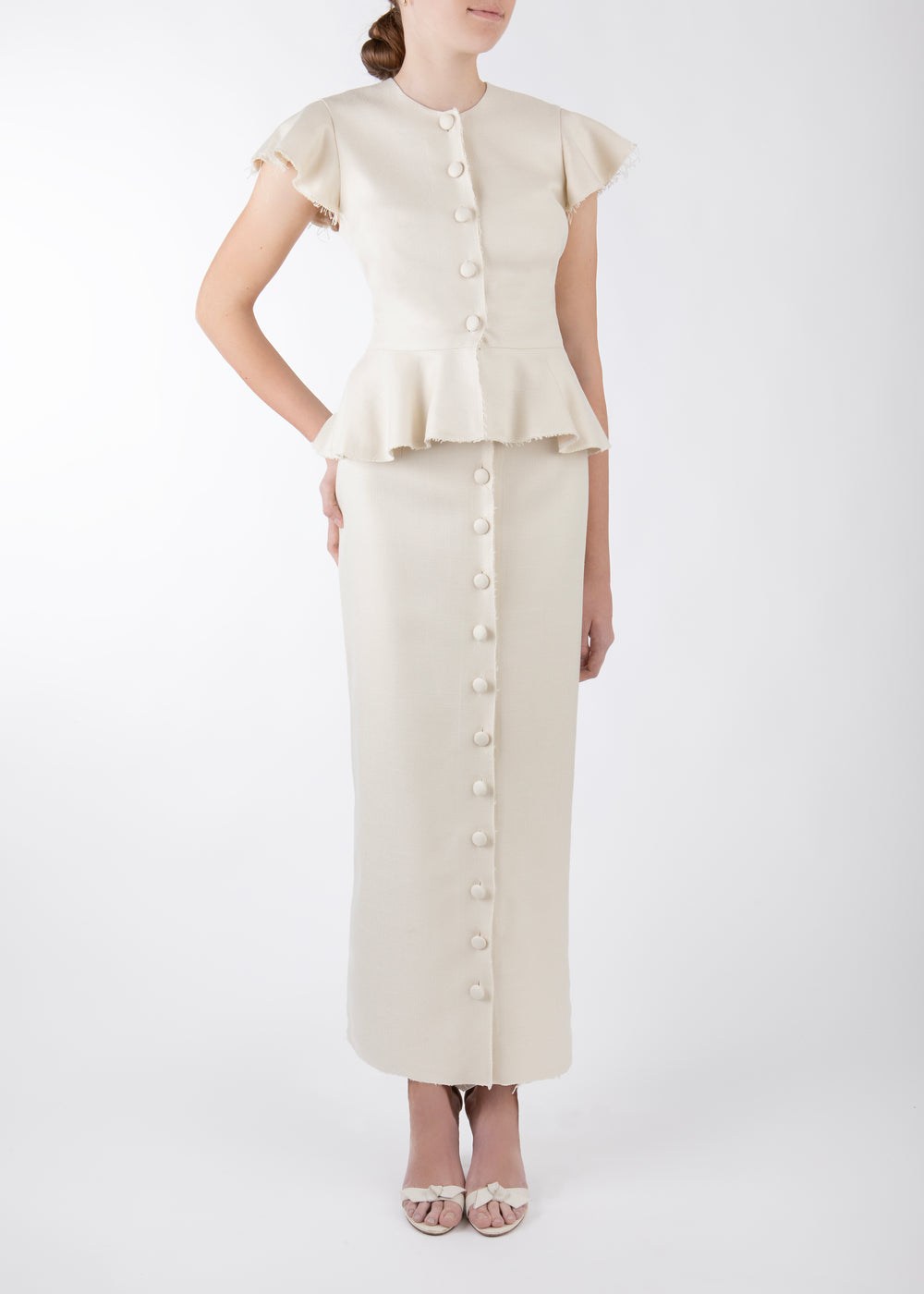 Front view of Shelley Skirt in ivory basketweave worn on model, high-waist midi with center button-front and raw-edge hem