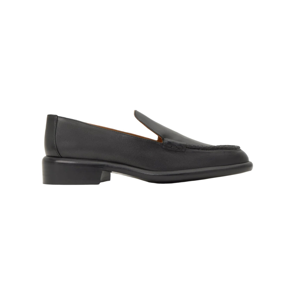 Side view of the Erika flat buffalo nappa moccasin showcasing its braided trim and low heel on a white background