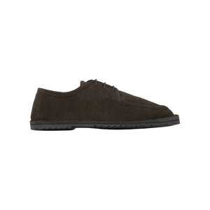 Side view of the Larry brown suede lace-up shoe showcasing visible stitching and flat TPU sole on a white background