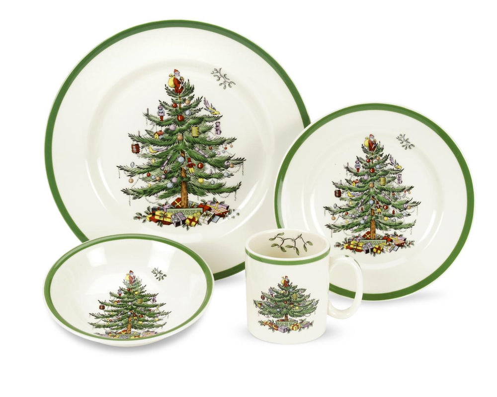 Front view of 4-piece Christmas Tree place setting with dinner plate, salad plate, bowl and mug, green rims and central Christmas tree motif on white background
