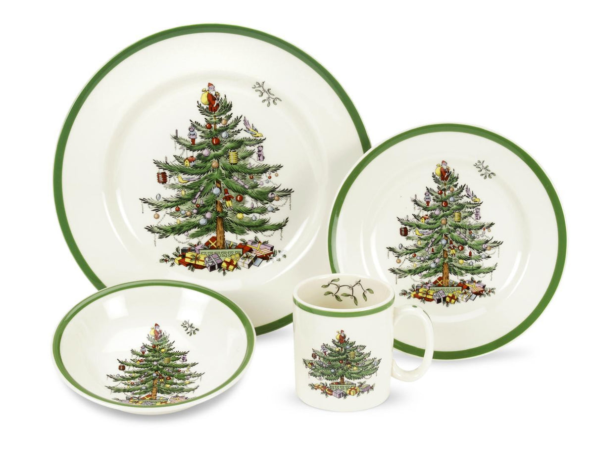 Front view of 4-piece Christmas Tree place setting with dinner plate, salad plate, bowl and mug, green rims and central Christmas tree motif on white background