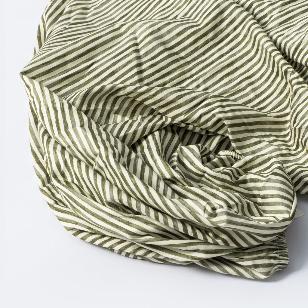 Crib Sheet in GOTS Certified Organic Brushed Cotton by Nate Berkus in Juniper Stripe