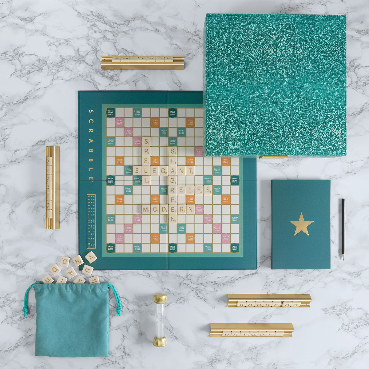 Top view of Scrabble Del Mar Shagreen Edition showcasing aquamarine faux-shagreen box and premium components on marble