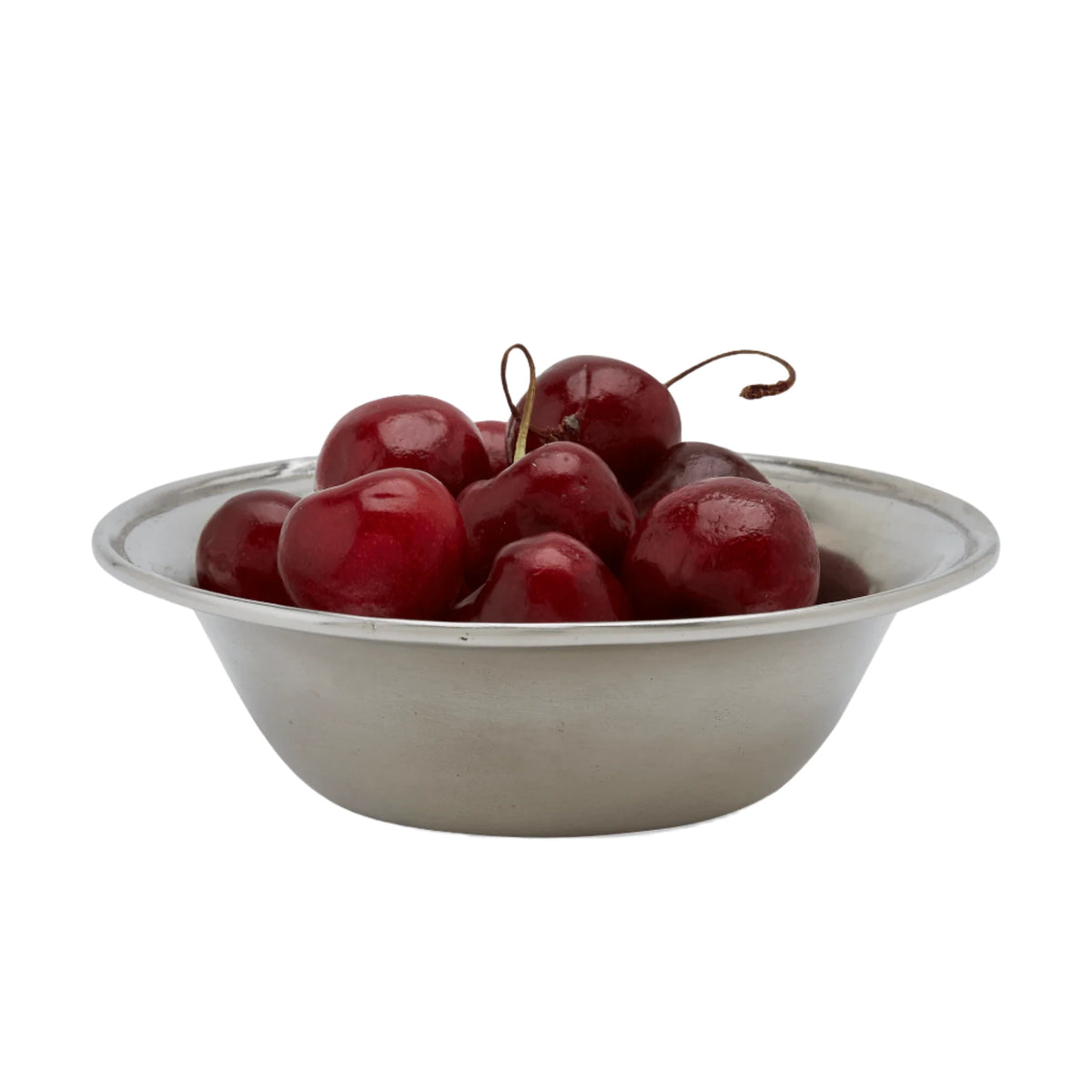 Front view of the small Lombardia Bowl showcasing its subtle raised edge and pewter finish with red cherries on a white background