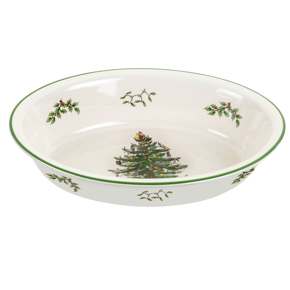 Angled view of Spode 12.5-inch oval rim dish with Christmas tree center and holly border on white background