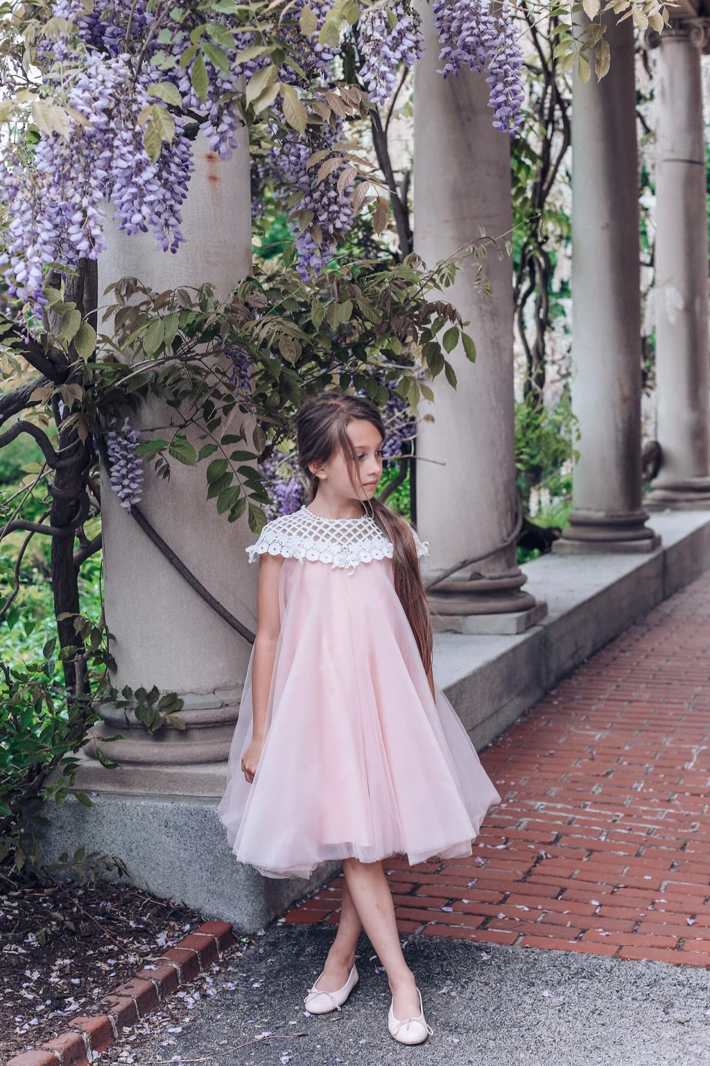 Girls pink tulle dress with flower details styled for a special occasion 