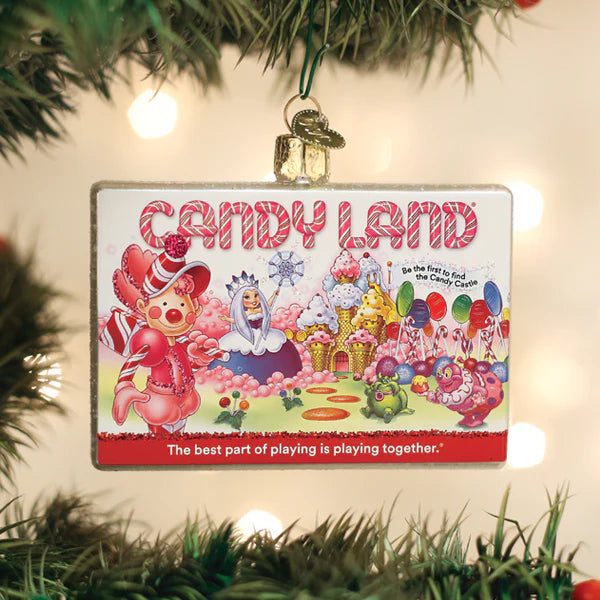 Front view of Candy Land glass ornament showing colorful board-game artwork with CANDY LAND headline and the tagline The best part of playing is playing together, hanging on a Christmas tree