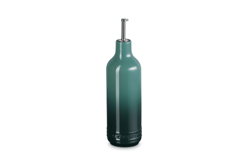 Front view of Signature Oil Cruet showcasing Artichaut green stoneware body and stainless steel curved pour spout on a plain background