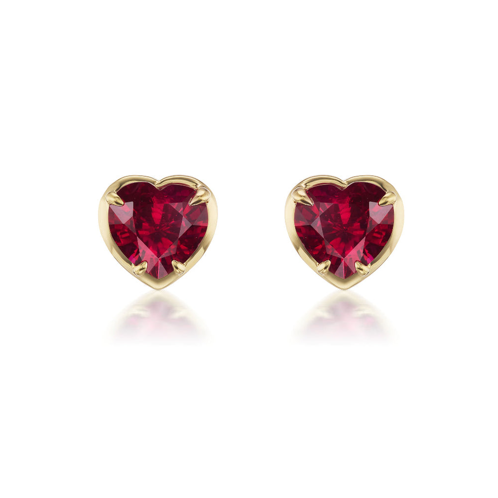 The Ruby Heart Studs in Yellow Gold feature heart-shaped rubies bezel set in 18K yellow gold, elegantly displayed on a white background.