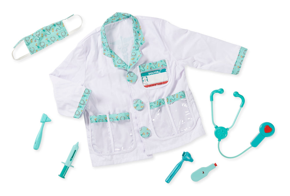 Flat lay of kids’ doctor costume set showing white coat with teal trim, mask, toy stethoscope and medical tools on white