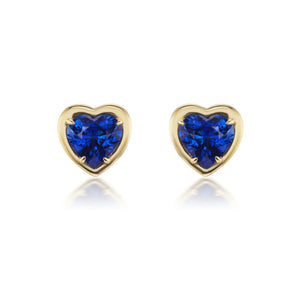 Blue Sapphire Heart Studs in Yellow Gold: Heart-shaped blue sapphires set in 18K yellow gold, these elegant studs are shown against a white background.
