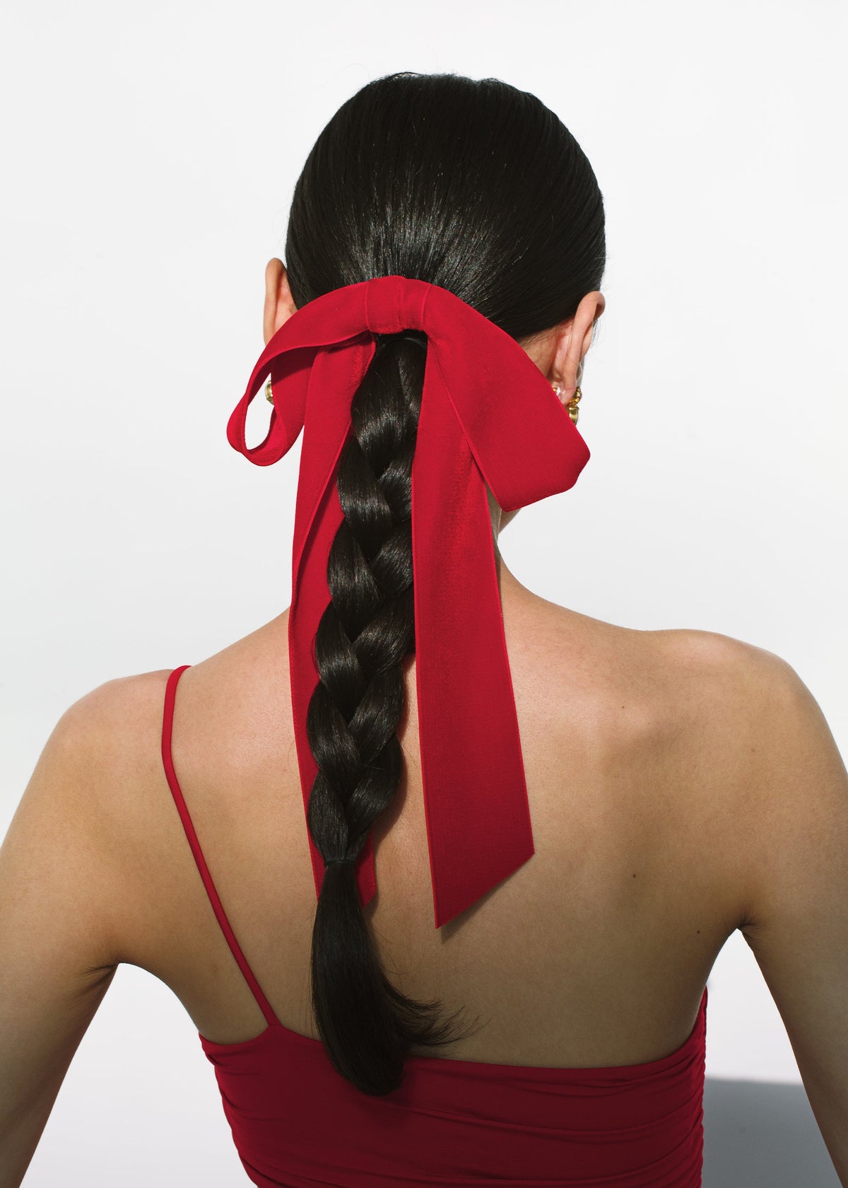 Back view of Adley Velvet Bow Barrette in Rouge showcasing oversized velvet bow loops on braided hair